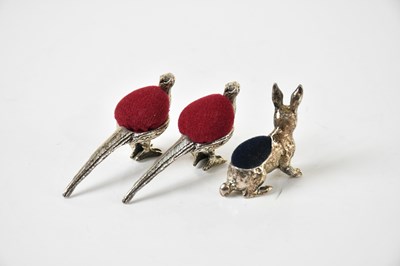 Lot 55 - A group of three pin cushions, each stamped...