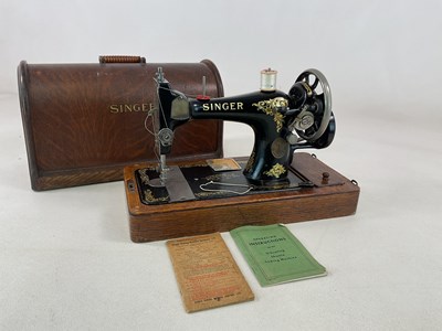 Lot 90 - A cased Singer sewing machine.