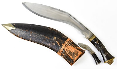 Lot 621 - A bone handled kukri with brass lion head...