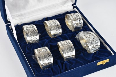Lot 432 - A set of six pierced white metal napkin rings,...