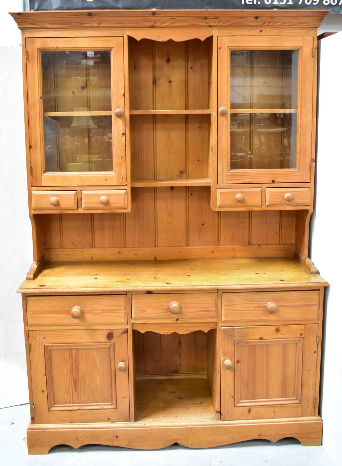 Lot 14 - A Victorian-style pine dresser, the top with a...