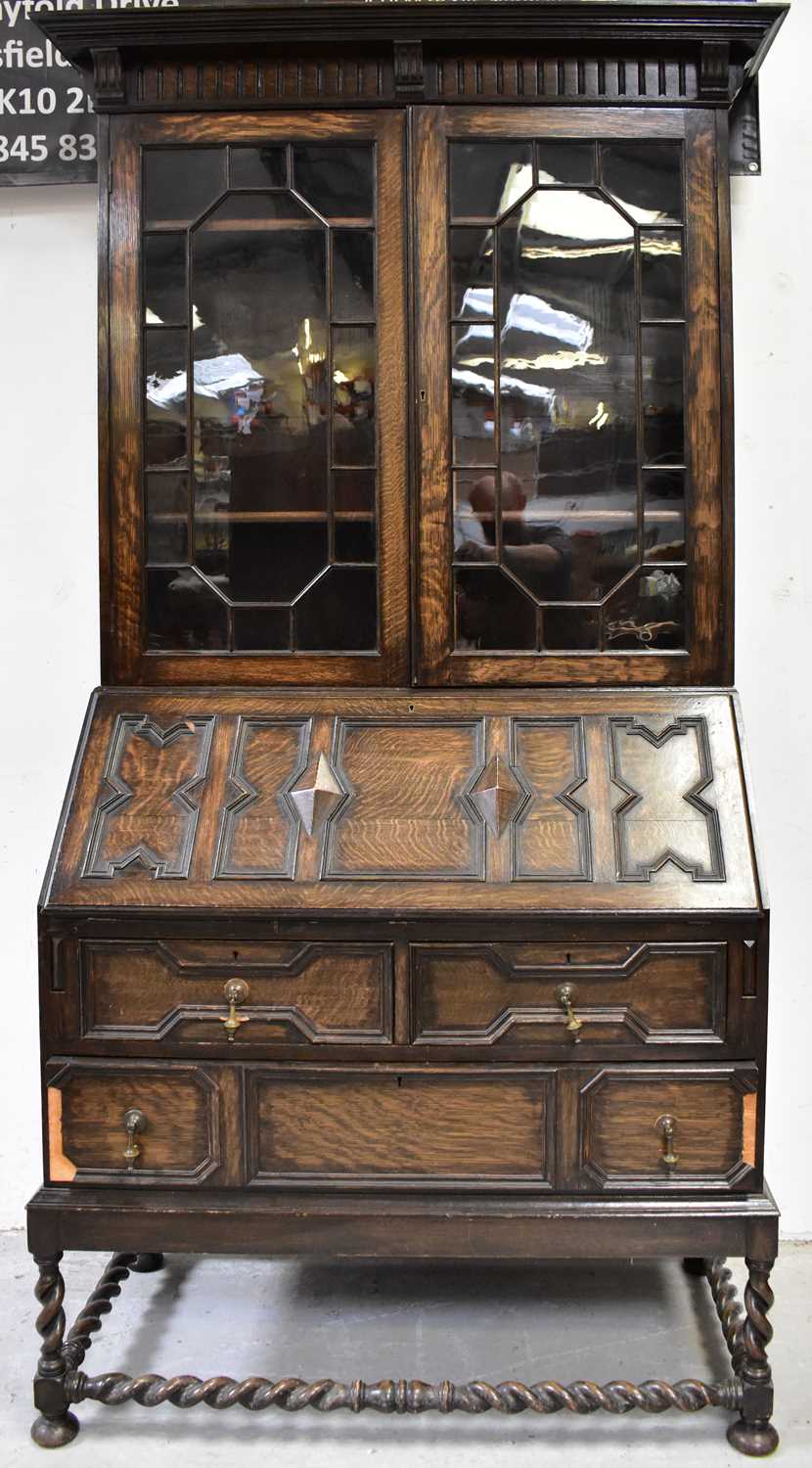 Lot 12 - An early 20th century oak bureau bookcase in...