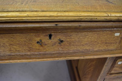Lot 47 - An Edwardian oak partners' desk, with an...