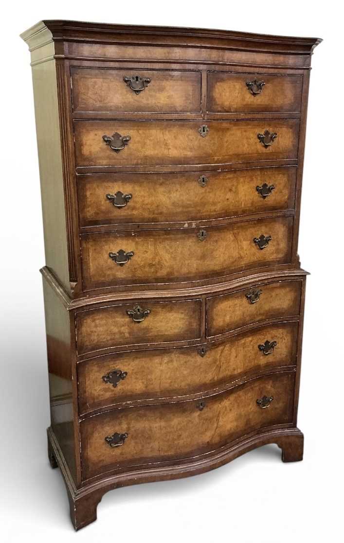 Lot 24 - A reproduction walnut serpentine front chest...