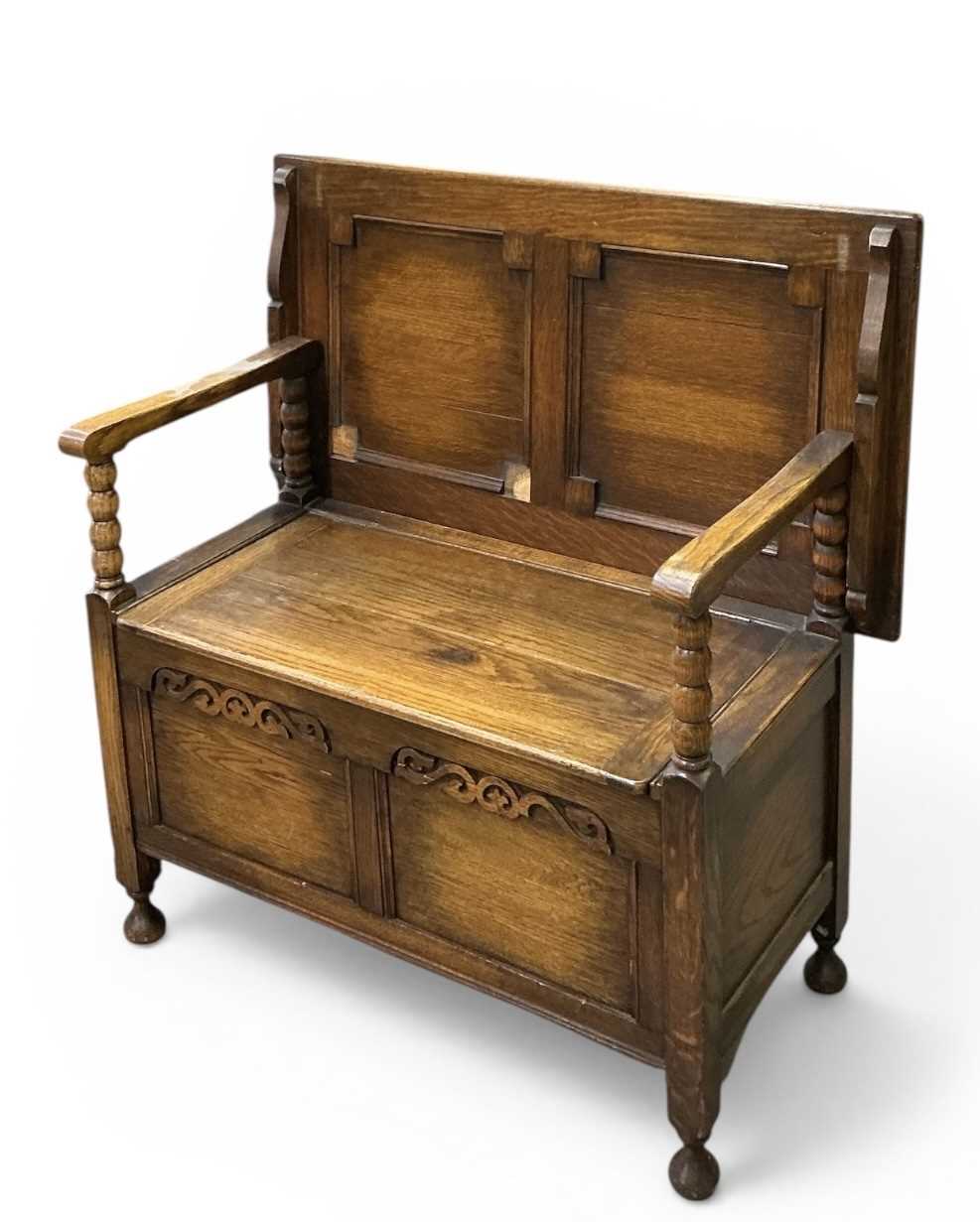 Lot 47 - An early 20th century carved oak monk’s bench,...