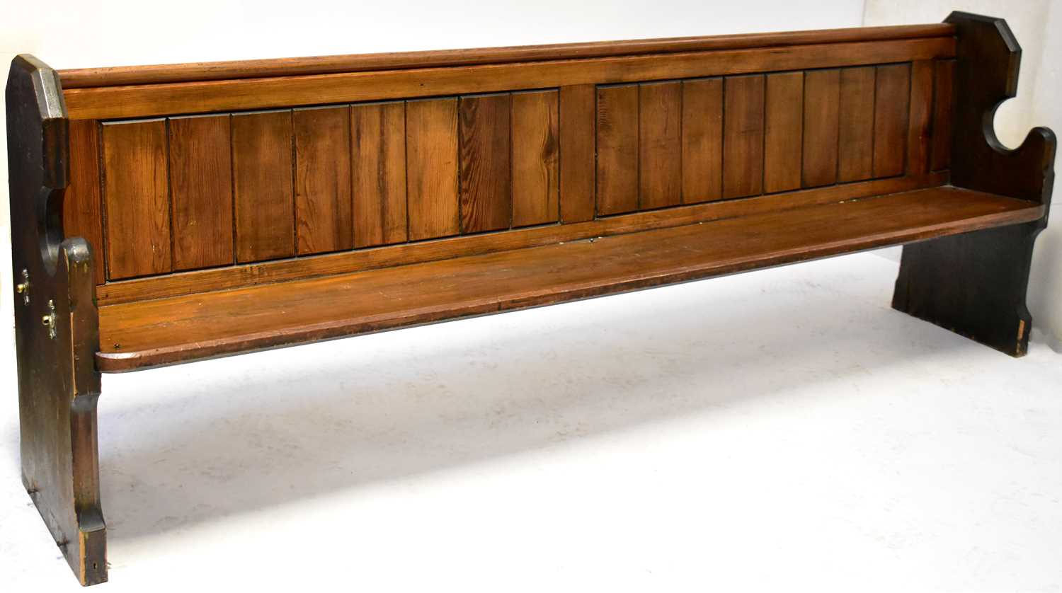 Lot 4 - A pitch pine church pew with Gothic-style ends,...