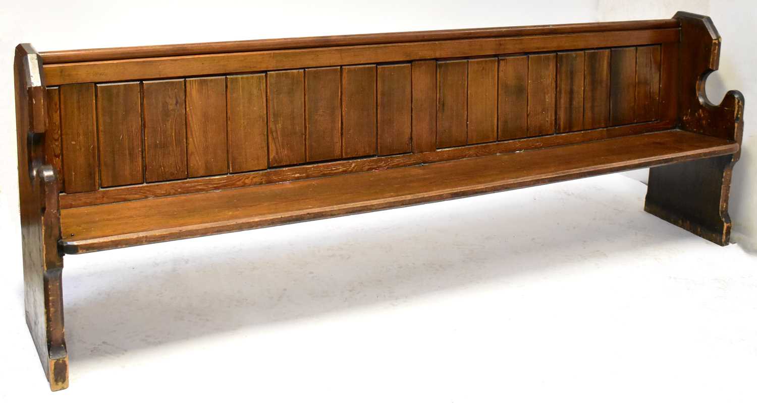 Lot 1 - A pitch pine church pew with Gothic-style ends,...