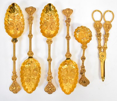 Lot 669 - A set of four gold-plated serving spoons,...
