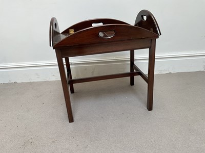 Lot 101 - A reproduction mahogany folding butlers tray...