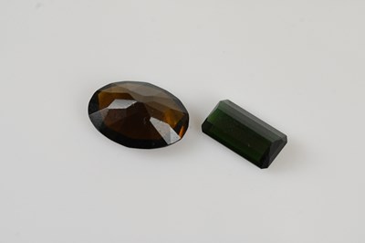 Lot 265 - LOOSE GEMSTONES; an emerald cut green...