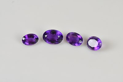 Lot 54 - LOOSE GEMSTONES; four oval cut amethysts,...