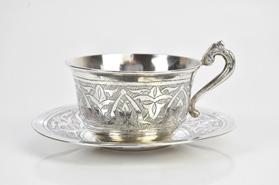 Lot 381 - An Eastern white metal teacup and saucer,...