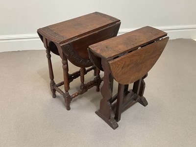 Lot 2069 - A 1920s carved oak drop-leaf dining table,...