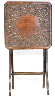 Lot 25 - An early 20th century carved oak folding side...