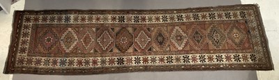 Lot 285 - An eastern runner with stylised lozenge motifs...
