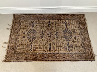 Lot 290 - A dark brown rug - auspicious symbols