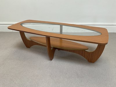 Lot 2124 - A 1970s teak effect glass top coffee table,...