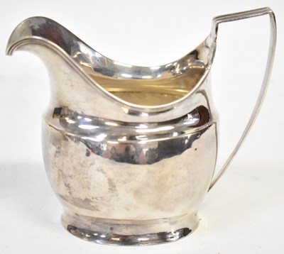 Lot 770 - A Georgian silver helmet shaped milk jug, with...