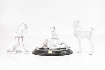 Lot 1198 - LLADRO; three models of unicorns, tallest 24cm,...