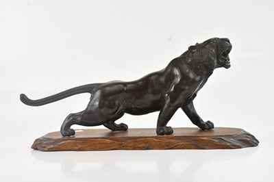 Lot 1080 - A Japanese hollow cast bronze model of a tiger,...