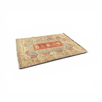 Lot 2167 - A large orange ground wool Milus carpet, with...