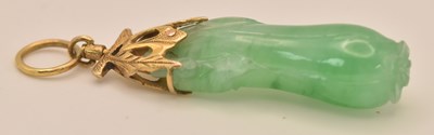 Lot 1410 - A Chinese yellow metal mounted carved green...