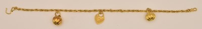 Lot 1492 - A Chinese yellow metal rope twist charm...