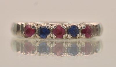 Lot 1332 - A white metal ruby and sapphire set five stone...