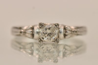 Lot 1274 - A 14K white gold diamond solitaire ring, the...