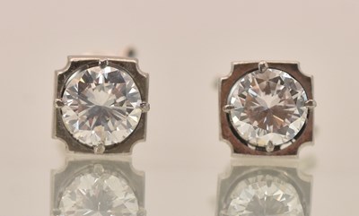 Lot 1436 - A pair of white metal diamond solitaire ear...