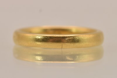 Lot 1255 - A Chinese yellow metal band ring, size J,...