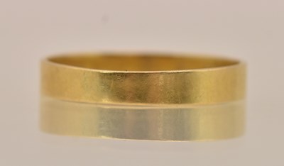 Lot 1315 - A Chinese yellow metal band ring, inscribed...