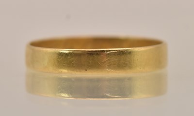 Lot 1316 - A Chinese yellow metal band ring, inscribed...