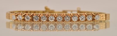 Lot 1490 - A yellow metal diamond set line bracelet, set...