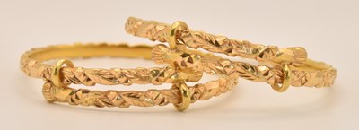 Lot 1485 - A pair of Chinese carved yellow metal...