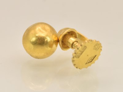 Lot 1449 - A Chinese yellow metal ear stud, with screw...