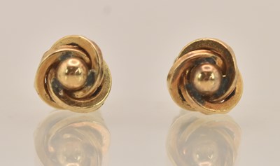 Lot 1464 - A pair of yellow metal twist ear studs, both...