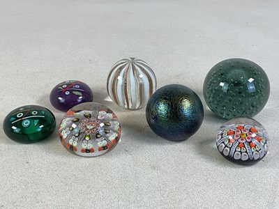 Lot 384 - Seven decorative glass paperweights, including...