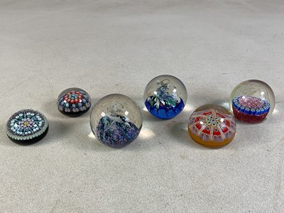 Lot 387 - Six decorative glass paperweights, comprising...