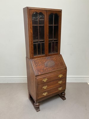 Lot 2039 - A mid 20th century oak bureau bookcase, with...