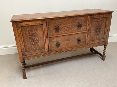 Lot 2031 - A 1920s oak sideboard with carved doors and...