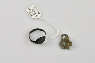 Lot 1194 - An early Saxon ring and a pendant (2).