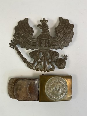 Lot 213 - A WWI German pickle helmet badge and belt buckle.