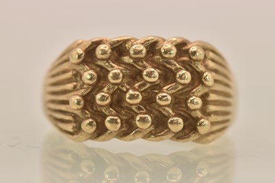 Lot 1312 - A 9ct yellow gold textured 'knot' ring,...