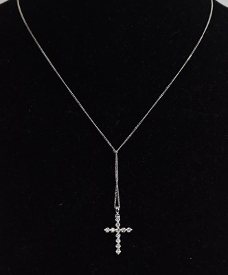 Lot 1387 - An 18ct white gold diamond set cross pendant,...