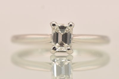 Lot 1244 - A platinum (950) emerald cut diamond solitaire...