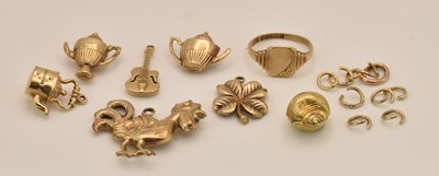 Lot 1376 - Seven 9ct yellow gold charms including a...