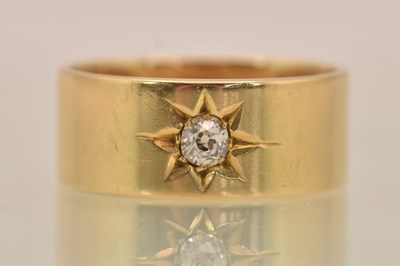 Lot 1239 - An 18ct yellow gold diamond set band ring, the...