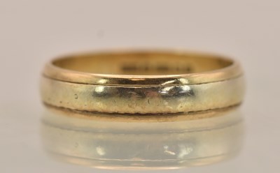 Lot 1307 - A 9ct yellow and white gold band ring, size Q,...