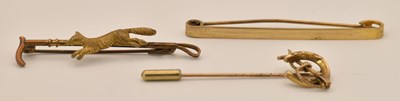 Lot 1479 - A 9ct yellow gold pin in the form of a riding...